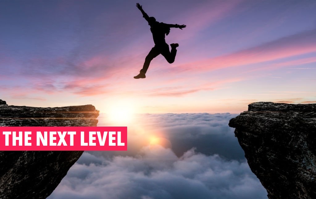 man jumping from one cliff to another